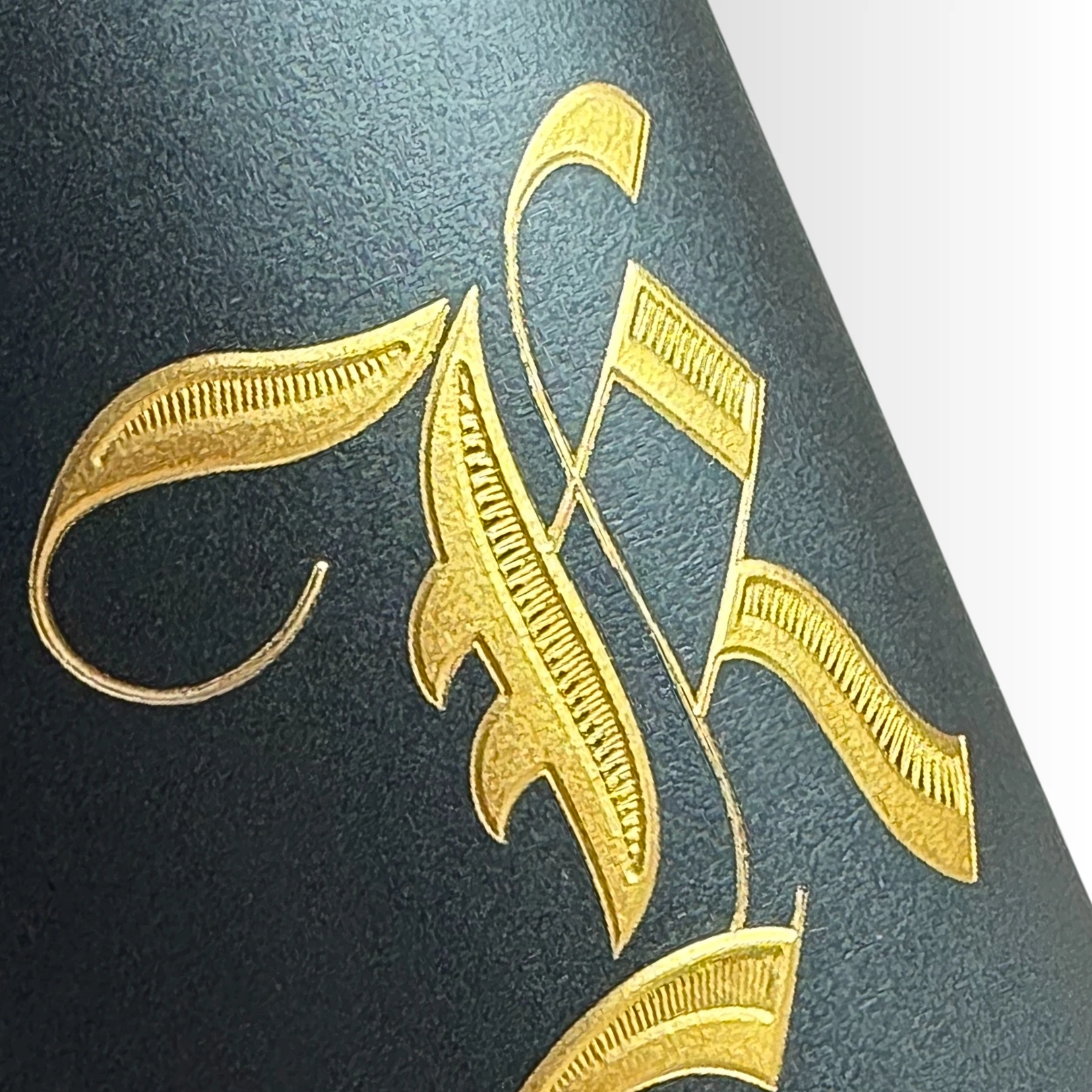 Close Up of Gold letter on matte black label